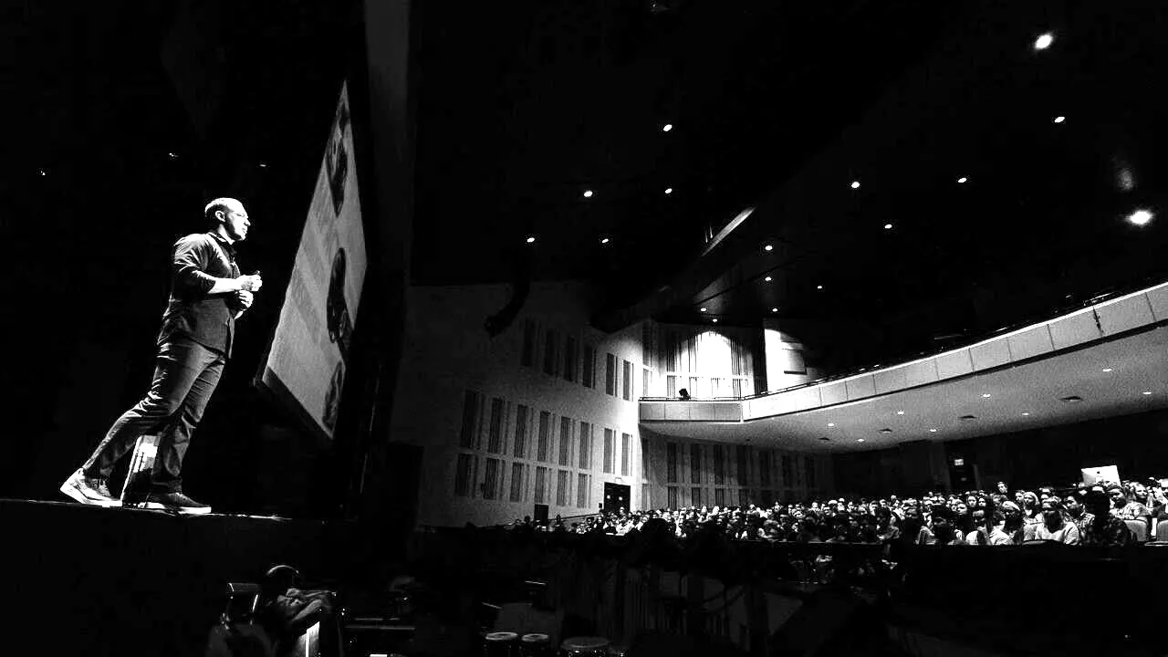 Ryan Hawk speaking to a full auditorium